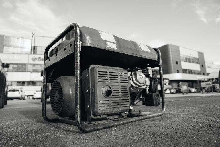 How do I properly dispose of the oil and gasoline from my portable generator?